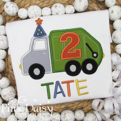 Personalized garbage truck birthday shirt for boys featuring an embroidered green and gray trash truck with a large orange number 2 and a blue party hat with a star. The name Tate is stitched in colorful block letters below. Perfect toddler boy birthday outfit for a truck-themed party, cake smash, second birthday celebration, or custom embroidered keepsake. Great for truck lovers and fun birthday photo shoots.
