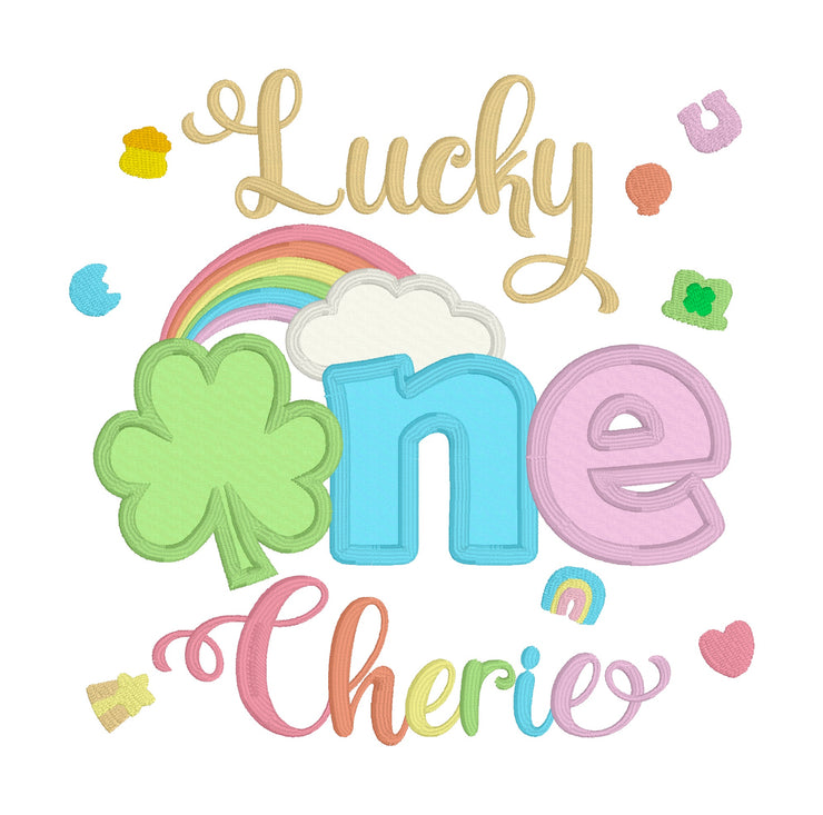 Lucky ONE first birthday embroidered shirt design for girls, featuring a green shamrock, colorful rainbow, white cloud, and St. Patrick’s Day themed accents. The words Lucky and one are stitched in gold, blue, and pink, with the personalized name Cherie underneath in rainbow colors. Perfect for St. Patrick’s Day birthday outfit, lucky first birthday party, cake smash outfit, toddler birthday photo shoot, or custom embroidered baby gift.